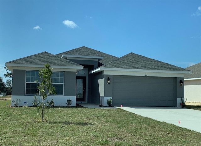 320 W Rexford Dr, Beverly Hills, FL 34465 - view of front of property featuring concrete driveway, a front lawn, a shingled roof, an attached garage, and stucco siding