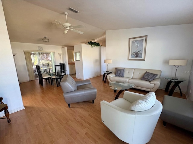 living room featuring light wood-type flooring, ceiling fan, and lofted ceiling