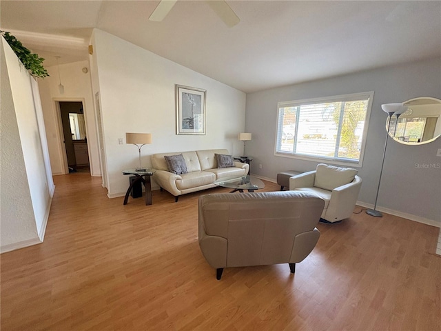 living room featuring light hardwood / wood-style flooring and vaulted ceiling