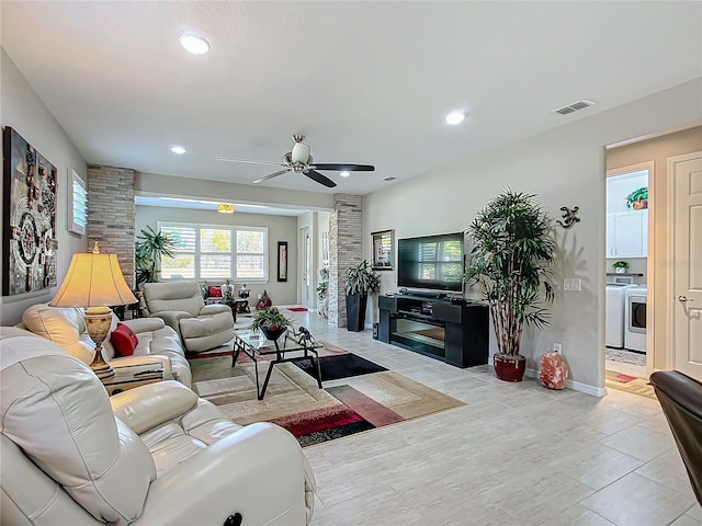 living room with ceiling fan and washer / clothes dryer