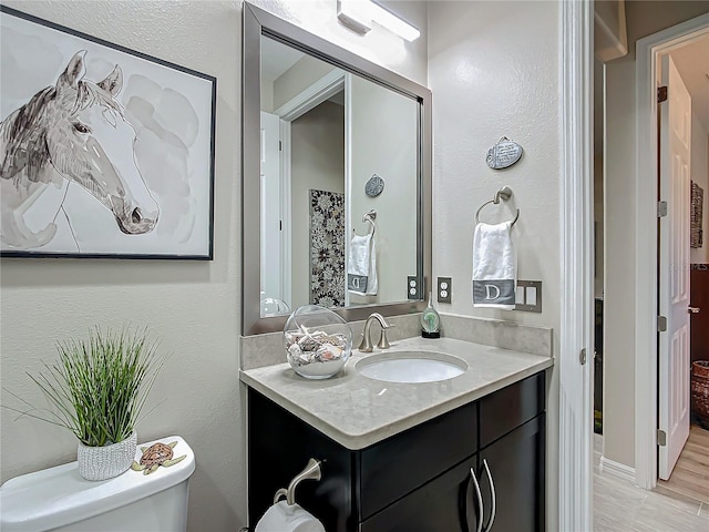 bathroom featuring vanity and toilet