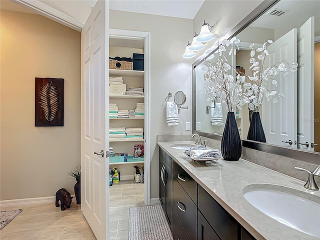 bathroom with tile patterned floors and vanity