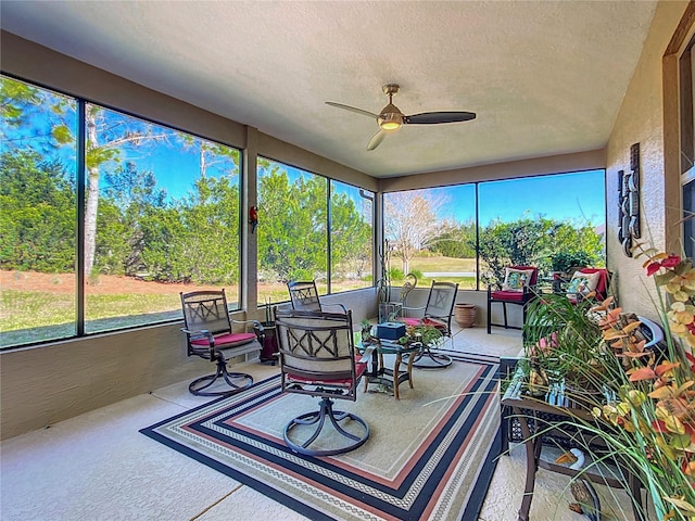 sunroom / solarium featuring ceiling fan