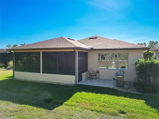 back of house with a patio area, a lawn, and a sunroom