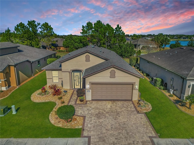 view of front of house with a lawn and a garage