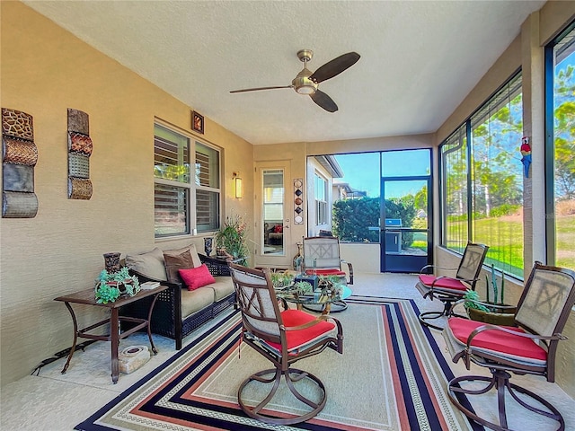 sunroom / solarium featuring ceiling fan