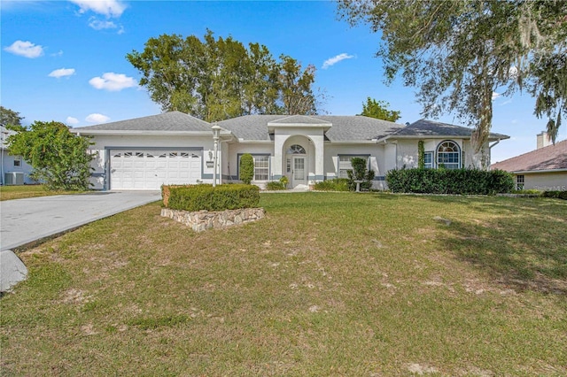 ranch-style home with a garage and a front lawn