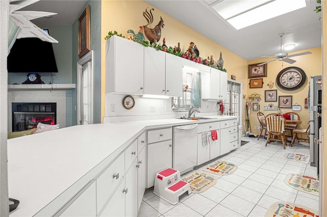 kitchen with white cabinetry, dishwasher, sink, ceiling fan, and light tile patterned floors