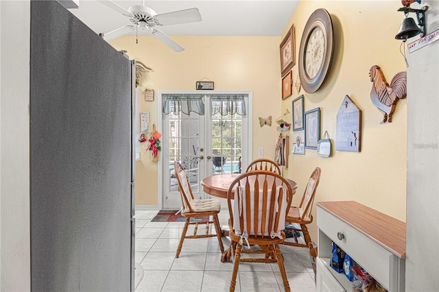 tiled dining area with ceiling fan and french doors