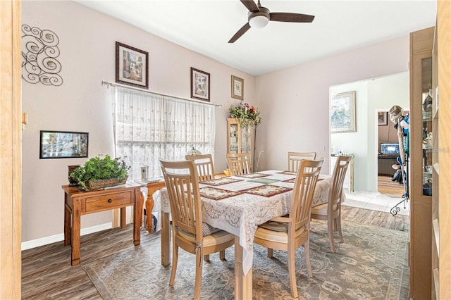 dining space with ceiling fan and wood-type flooring