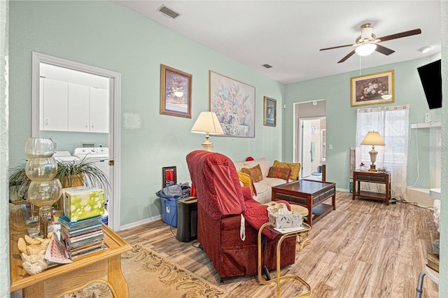 living room featuring light hardwood / wood-style flooring and ceiling fan