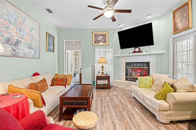 living room with ceiling fan and hardwood / wood-style flooring