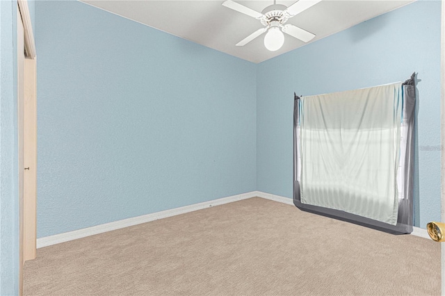 carpeted spare room with ceiling fan