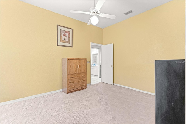 carpeted spare room with ceiling fan