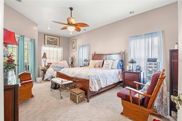 bedroom featuring multiple windows, carpet flooring, and ceiling fan