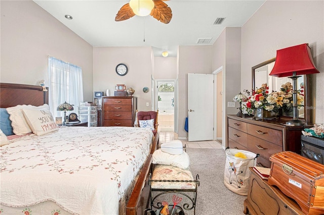 carpeted bedroom with ceiling fan and ensuite bath