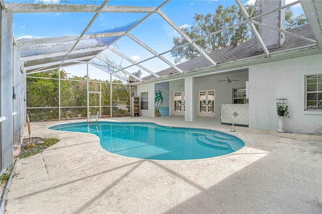 view of pool featuring a lanai, a patio area, and ceiling fan