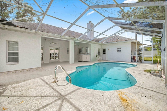 view of pool with a lanai, a patio area, and ceiling fan