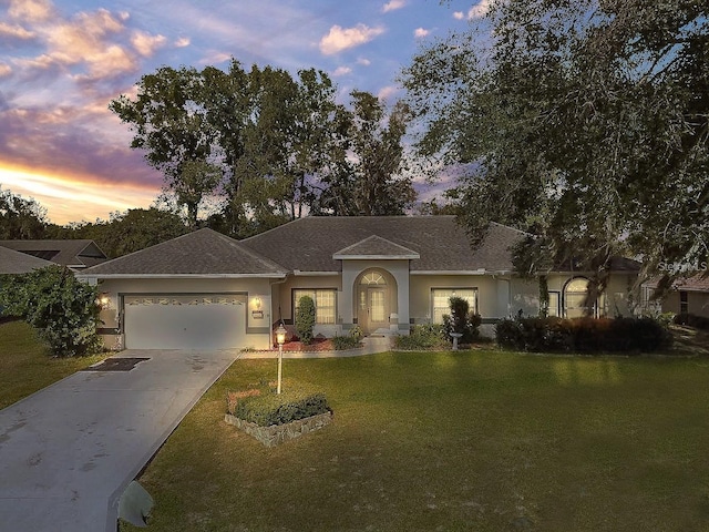 ranch-style home with a lawn and a garage