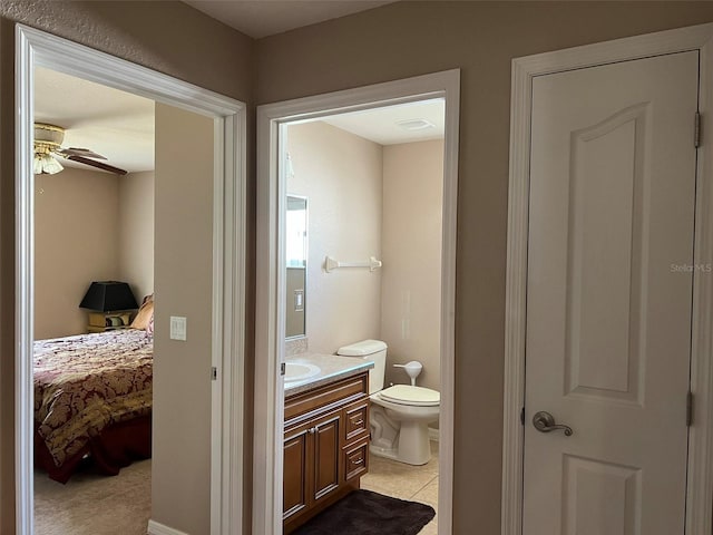 bathroom with vanity, toilet, and ceiling fan