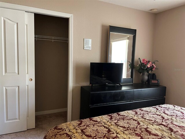 carpeted bedroom featuring a closet