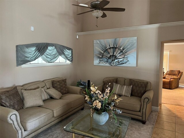 tiled living room featuring ceiling fan