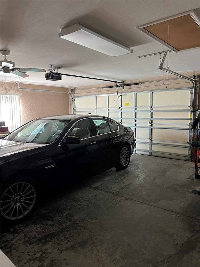 garage with ceiling fan and a garage door opener