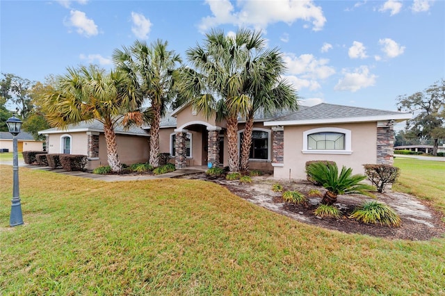 ranch-style house with a front yard and stucco siding