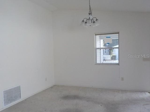 empty room featuring an inviting chandelier