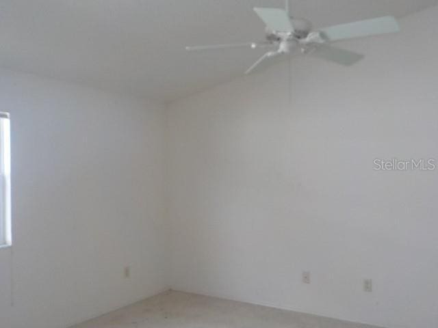 unfurnished room with ceiling fan