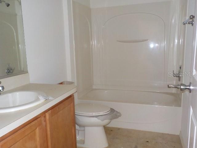 full bathroom featuring shower / bathing tub combination, vanity, and toilet