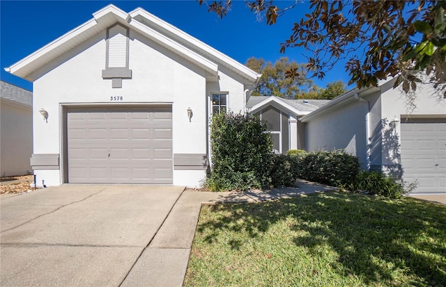 view of front of property with a garage and a front lawn