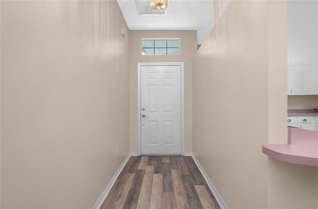 entryway featuring a towering ceiling and hardwood / wood-style flooring