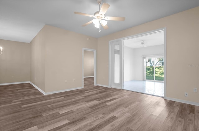 spare room with wood-type flooring and ceiling fan