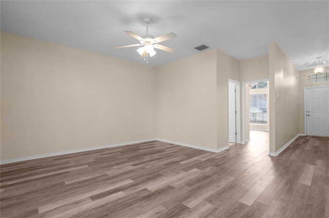 empty room featuring hardwood / wood-style flooring and ceiling fan