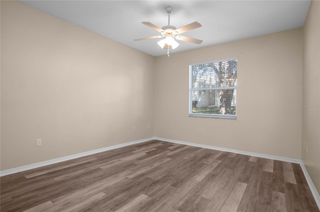 empty room featuring hardwood / wood-style flooring and ceiling fan