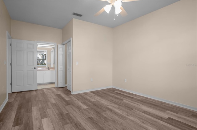 unfurnished bedroom with ceiling fan and light wood-type flooring