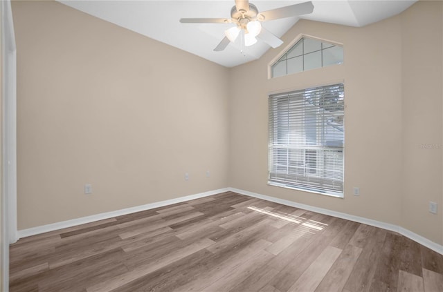 spare room with hardwood / wood-style floors, ceiling fan, and lofted ceiling