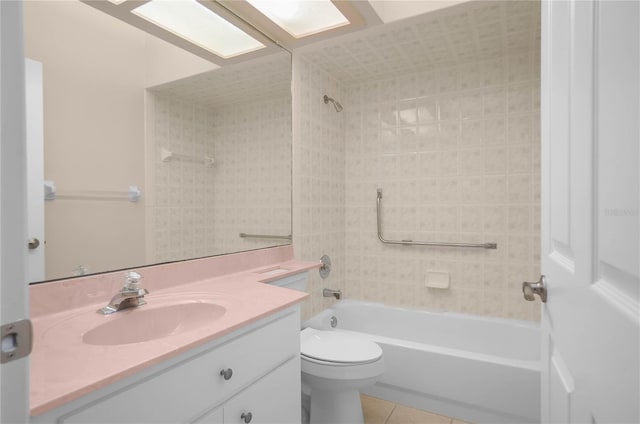 full bathroom with tile patterned floors, vanity, toilet, and tiled shower / bath combo