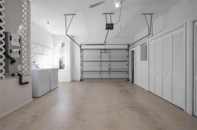 garage featuring heating unit, a garage door opener, and independent washer and dryer