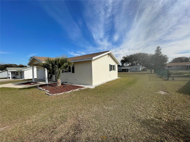 view of side of property featuring a garage and a yard