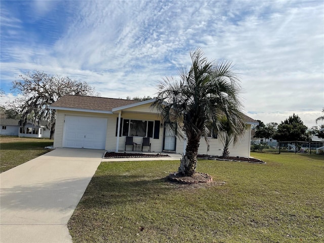 view of front of home with a front lawn, covered porch, and a garage