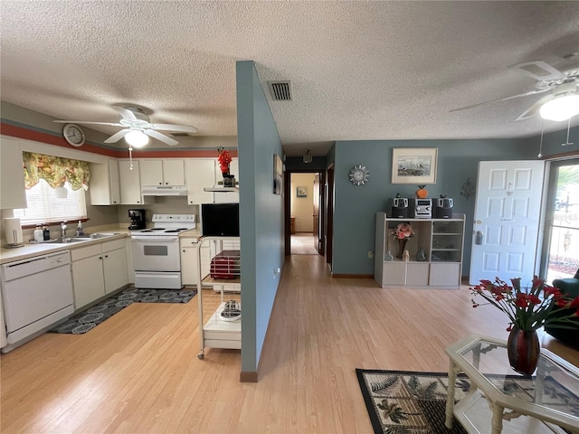 kitchen featuring white cabinetry, sink, white appliances, and light hardwood / wood-style flooring