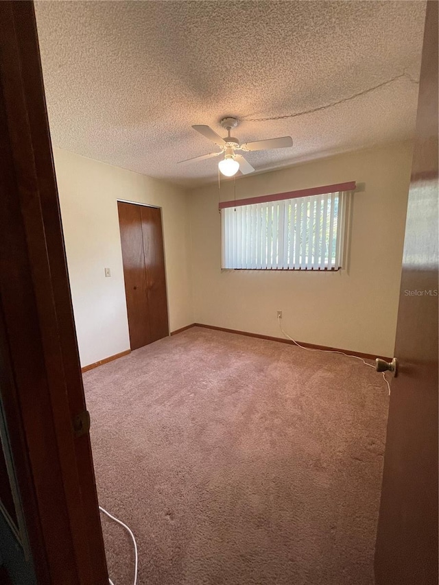 10949 SW 79th Ter, Ocala, FL 34476 - carpeted empty room with ceiling fan, a textured ceiling, and baseboards