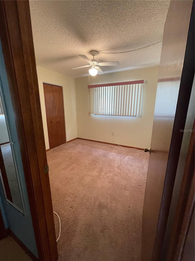 10949 SW 79th Ter, Ocala, FL 34476 - carpeted empty room featuring ceiling fan, a textured ceiling, and baseboards