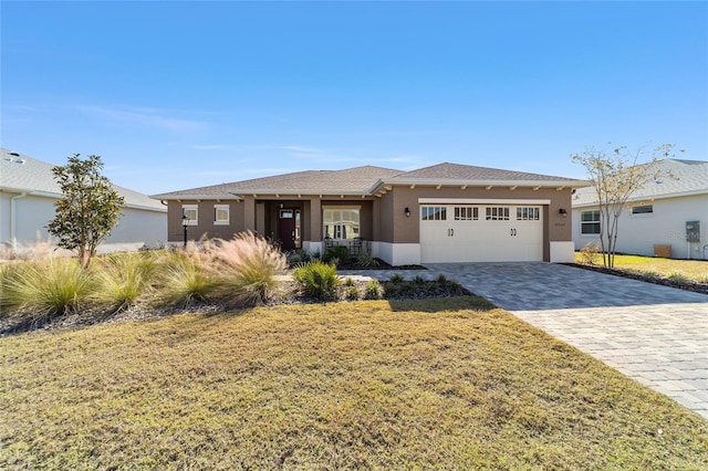 view of front of property with a garage and a front lawn