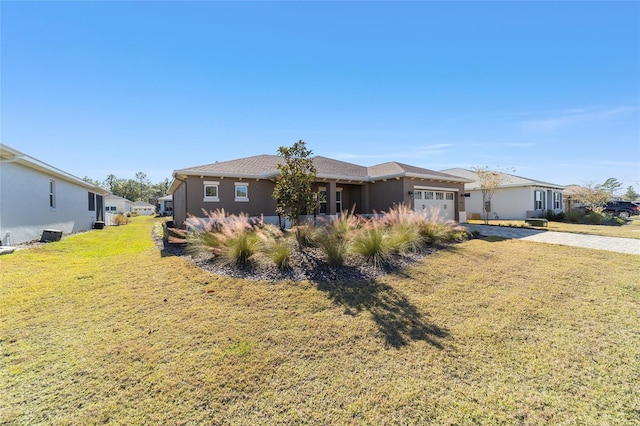 view of front of home with a garage and a front yard