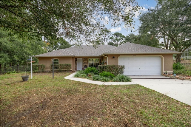 single story home featuring a front yard and a garage