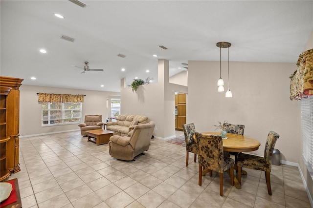 dining area with ceiling fan, light tile patterned floors, and vaulted ceiling