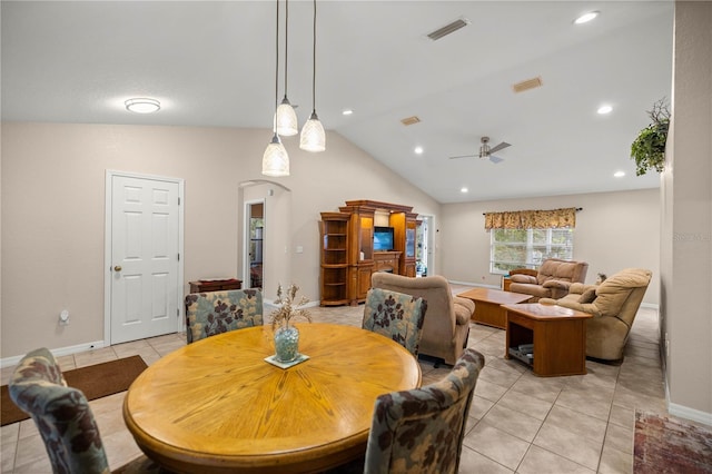 tiled dining room featuring ceiling fan and vaulted ceiling